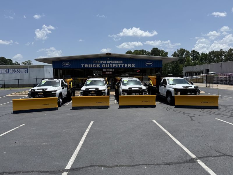 Four Meyer Snow plows and salt spreaders