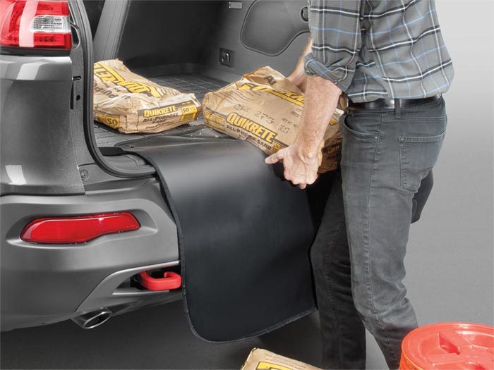 weathertech floorboard protector in back of SUV with quikcrete being put in the trunk area