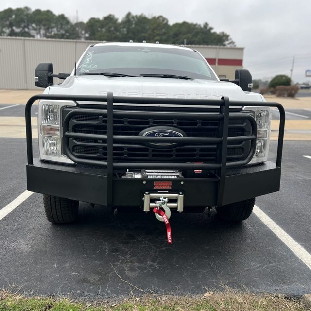 Front bumper with grille guard and winch installed on a white work truck in Bryant Arkansas