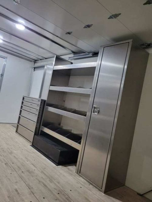 large sectioned shelves and closet with door installed in box truck