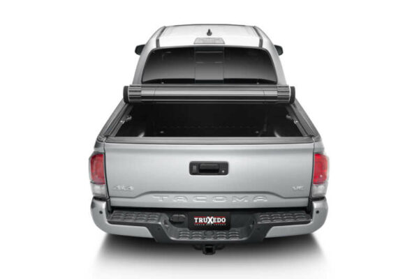 TruXedo Sentry tonneau cover installed on work truck and partially rolled up