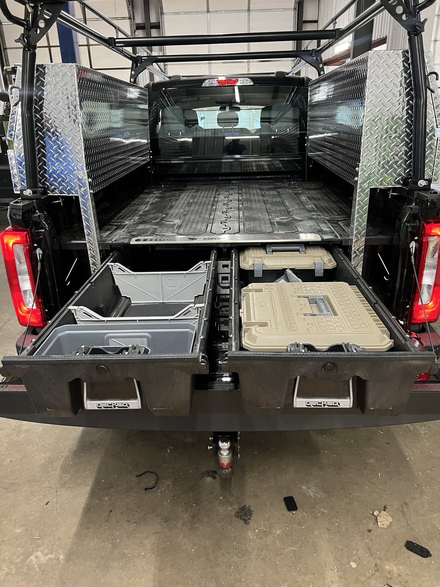 Work truck with utility bed that has pull out drawers under the bed