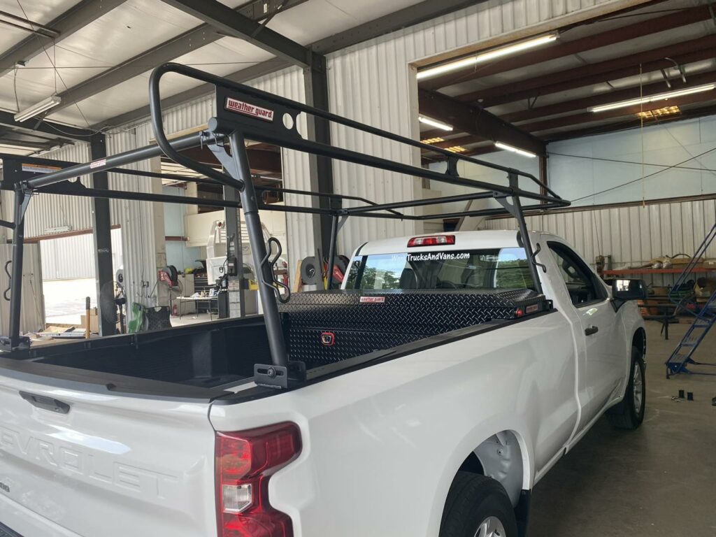 White work truck with new Weather Guard ladder rack and tool box installed over bed