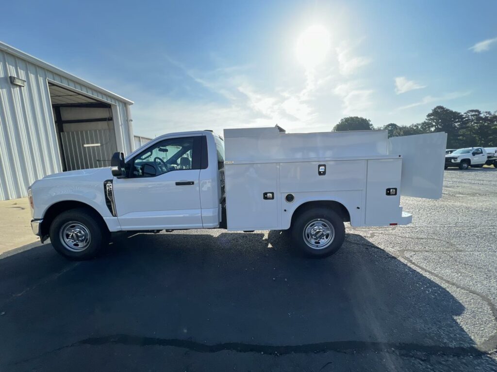 white work truck with utility bed installed and swing door on back