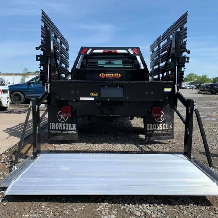 work truck with Ironstar Crossfire bed installed with a liftgate on the ground