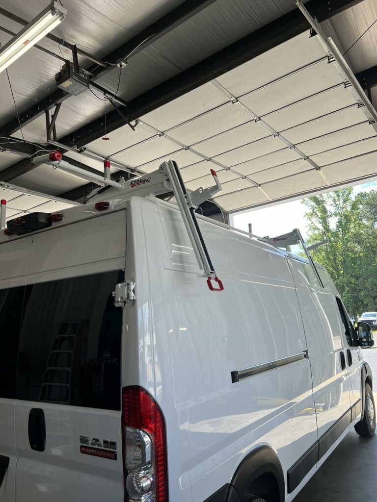 work van with new ladder racks installed in a garage