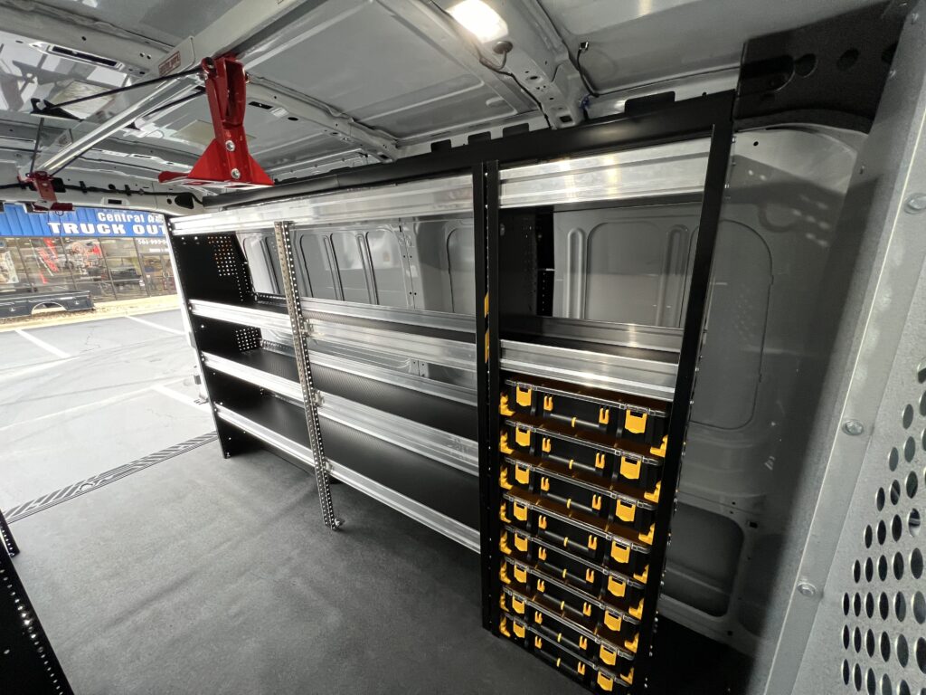 interior of work van with shelves and stacked storage containers